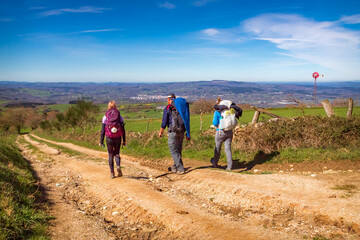 Pilgrims Hiking in Galicia Spain Countryside Road on the Way of St James Pilgrimage Trail Camino de...