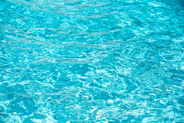 Abstract ripple wave and clear turquoise water surface in swimming pool, blue water wave for background and abstract design.