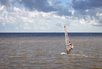 Man windsurfing on the Gulf of Mexico on a sunny afternoon