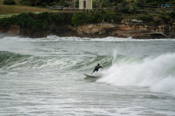 surfer in action catching waves at the beach