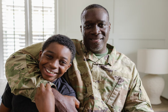 Feeling happy dad is home, family is complete, African American military, father and son
