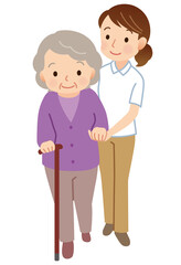 杖をついて歩く高齢者　寄り添う介護士