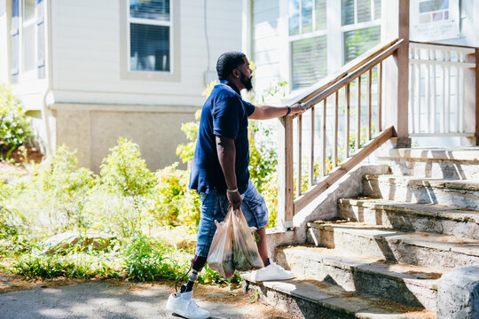 Man Walking Up Stairs With Prosthetic Leg