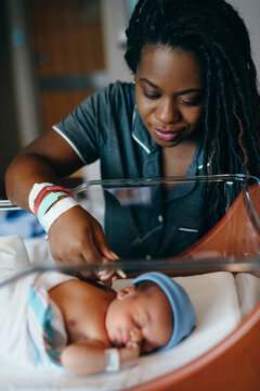 Black mom checks on newborn son at hospital 