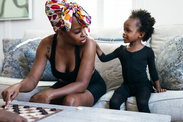 Daughter comforts mom while playing checkers game