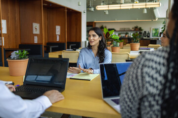 Middle Eastern business leader, having discussions with team, female