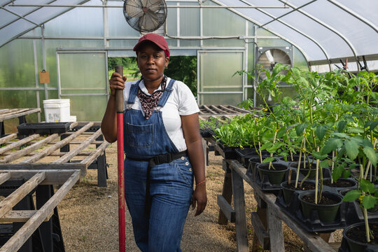 Portrait of female farmer in greenhouse