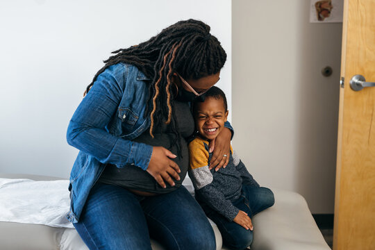 African American mother and son waits in exam room