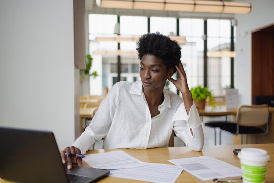 Thoughtful and focused Business woman with laptop in office, African American