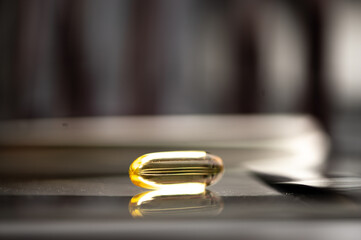 Tray of medicine filled with capsules and medicine strips with test tubes in background on a laboratory table with no people around