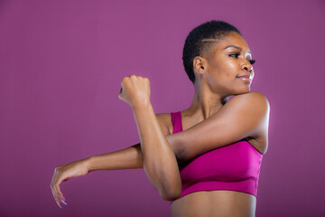 African American woman stretches her arms before workout exercise 