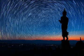 Night sky with stars and Biggest Buddha