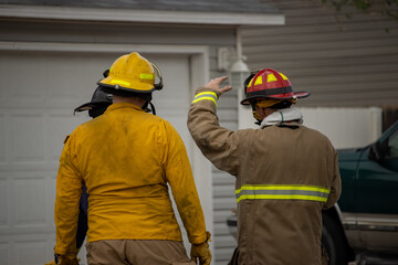 Firefighters Discuss Tactics While Defending Homes Against Wildfire