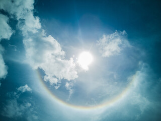Naklejka na ściany i meble Natural phenomenon Sun halo on blue sky background