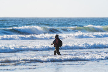 fisherman in the ocean at the beach