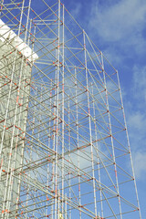 Scaffolding metal steel structure, construction on blus sky background or backdrop. August 2021. Tallinn, Estonia, Europe