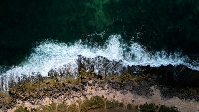 Waves crashing against rock shore In Hawaii. Drone footage