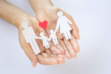 Paper family in the palm of your hand. Accident insurance concept, personal insurance that takes...