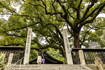 Japanese woman standing in front of Japanese temple