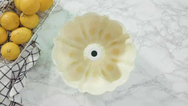 Step by step. Flat lay. Lemon pound cake batter in a baking bundt pan ready to be baked.