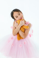 Portrait isolated studio shot of little Asian cute ballerina kid in pink beautiful elegance rose...