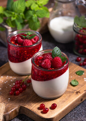 raspberry panna cotta with berries and mint, Italian dessert, home cooking. creamy dessert in a glass