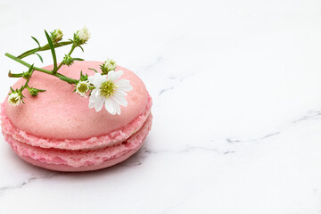 Close up of  a pink macaroons or French macarons on a white marble top background.