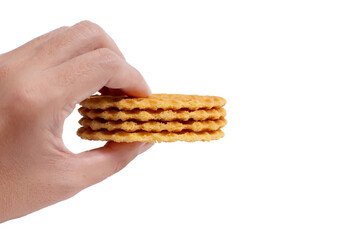 Hand-holding Stack of crispy waffles isolated on a white background.