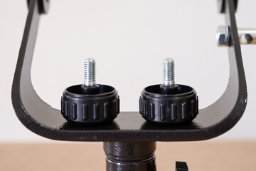 Yoke altazimuth mount, thumb screw, and vertical fine adjustment rod. Telescope parts on wooden...