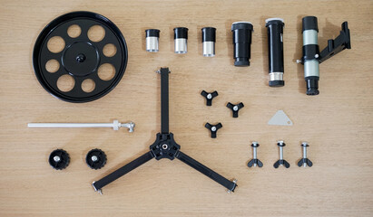 All package included. Telescope parts on wooden table. Astronomy lesson exploring parts of...