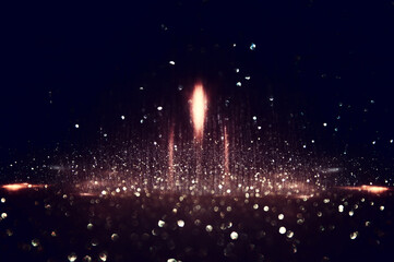 background of abstract gold and black glitter lights. defocused