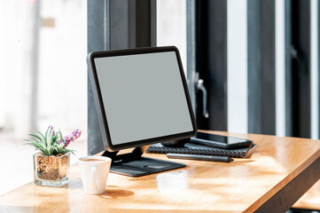 Fototapeta premium Mock up blank screen tablet on wooden table.