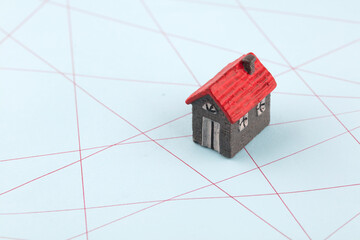 Small house model on messy red line
