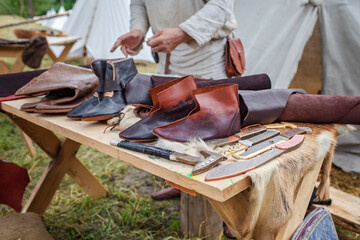 Craft shoemaker demonstrates the process and the products of his work on the festival workshop,...