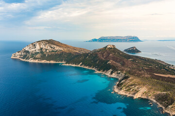 Stunning aerial view of Capo Figari bathed by a turquoise water. Capo Figari is a limestone promontory located in Gallura, in the north-east of Sardinia, Italy.