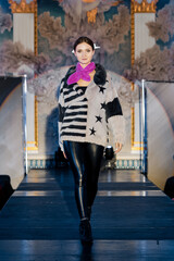 Fashion model walks on runway in fur coat
