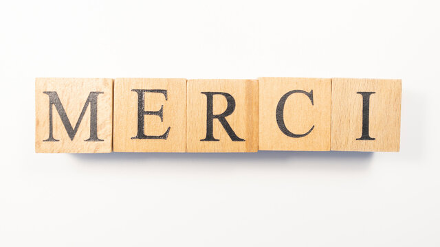 The word Merci was created from wooden cubes.