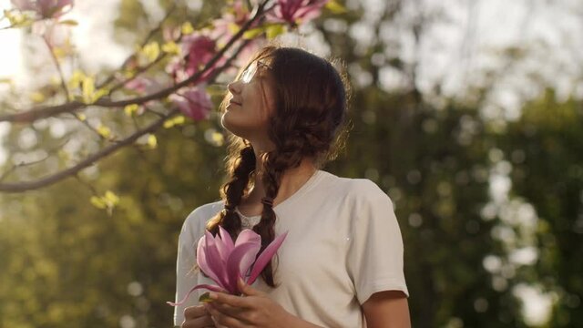 Spring Beauty Portrait of a Woman with Flower Outdoors