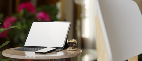 Portable tablet blank screen mockup with magic keyboard, smartphone , coffee on side table