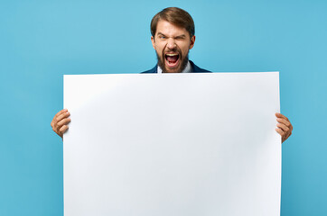 man with white poster advertising copy space blue background