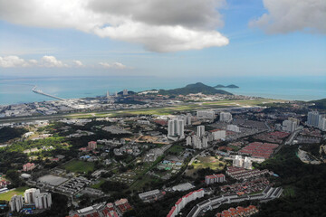 Obraz premium Aerial view of Bayan Lepas Industrial park, residential houses and commercial shop building on a sunny day in Penang, Malaysia.