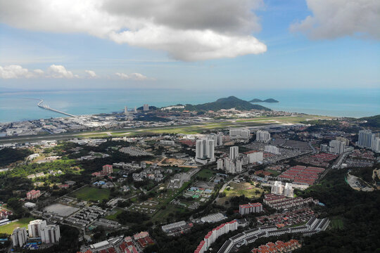 Aerial view of Bayan Lepas Industrial park, residential houses and commercial shop building on a sunny day in Penang, Malaysia.
