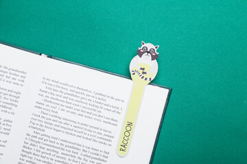 Cute bookmark with book on color background