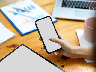 Fototapeta na wymiar smartphone and tablet blank screen mockup used by woman