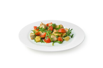 Warm vegetable salad with meat and greens on white plate isolated on white