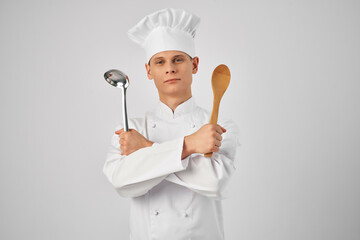 a man in a chef's uniform kitchen utensils work in a restaurant Professional