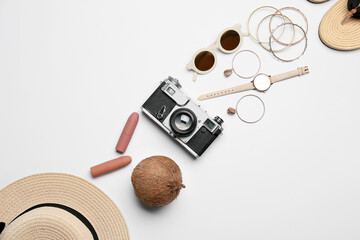 Set of female accessories, photo camera and coconut on white background