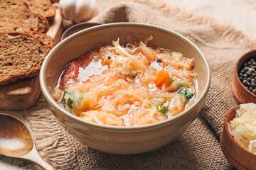 Bowl with tasty sauerkraut soup on table, closeup