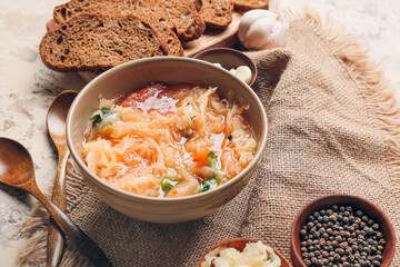 Bowl with tasty sauerkraut soup on table