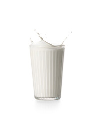 Glass of tasty milk with splashes on white background